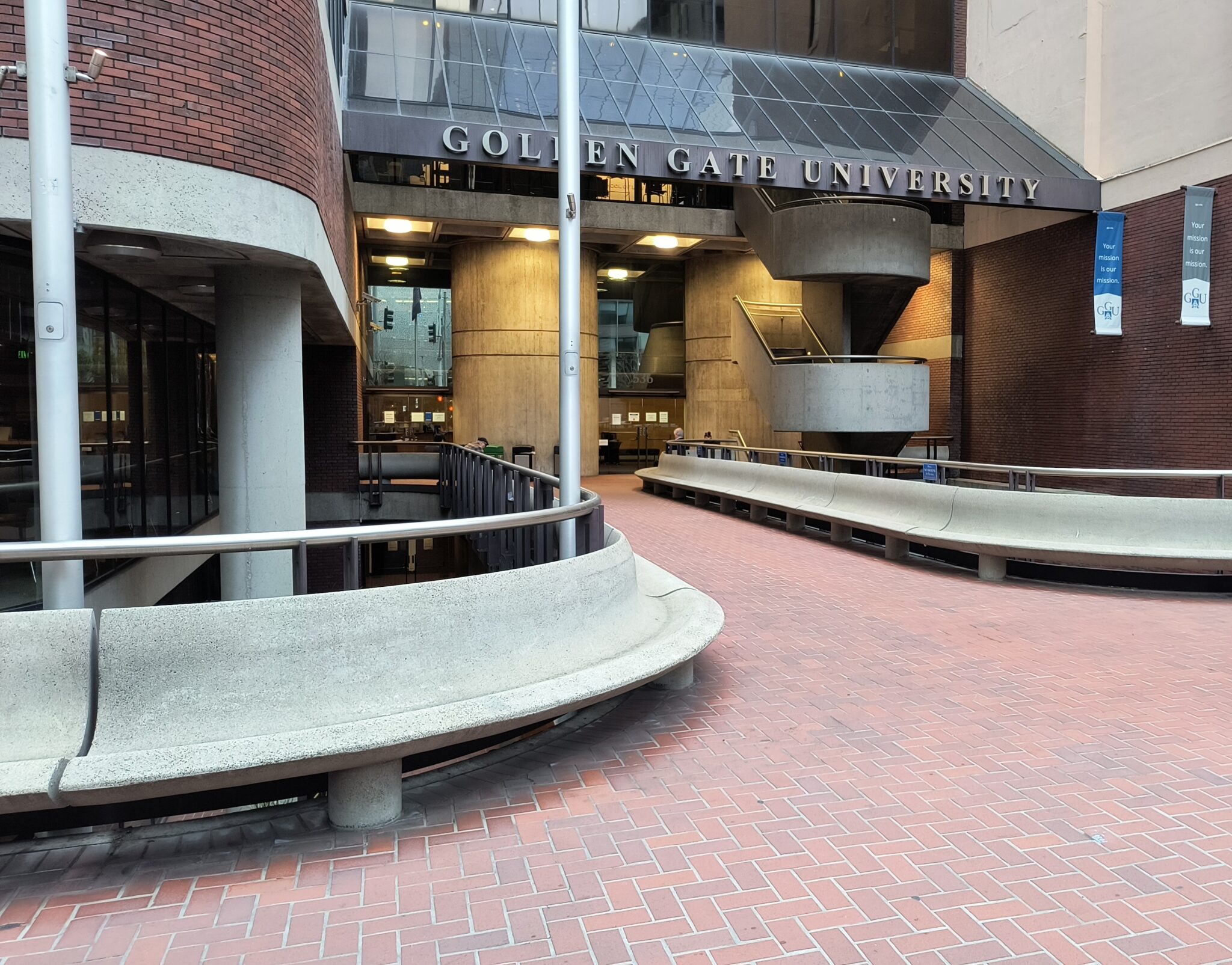 Golden Gate University building with a long bench wrapped around the entry into the building 